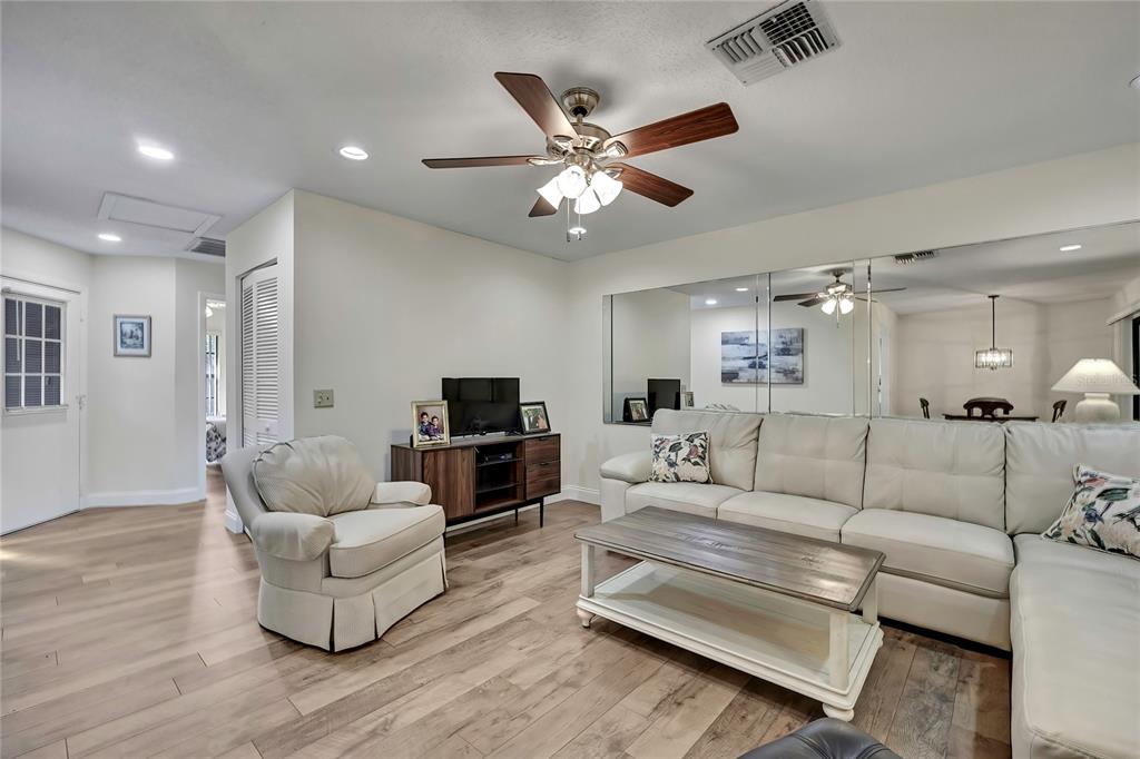 6365 Nature Preserve Lane Spring Hill, FL 34606 - Photo 11 of 26 a living room with furniture and a wooden floor
