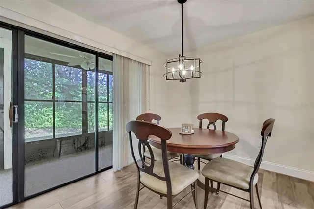 a view of a dining room with furniture wooden floor and a chandelier