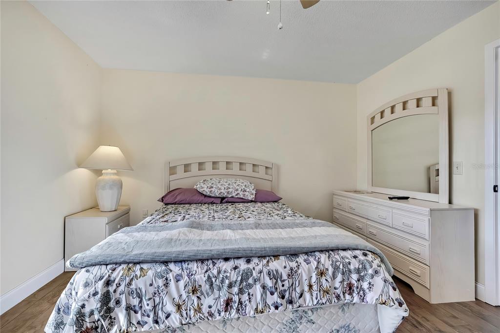 6365 Nature Preserve Lane Spring Hill, FL 34606 - Photo 14 of 26 a bedroom with a bed and a mirror