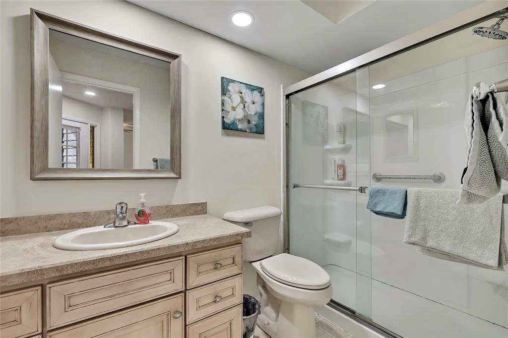 6365 Nature Preserve Lane Spring Hill, FL 34606 - Photo 16 of 26 a bathroom with a granite countertop sink a toilet a mirror and shower