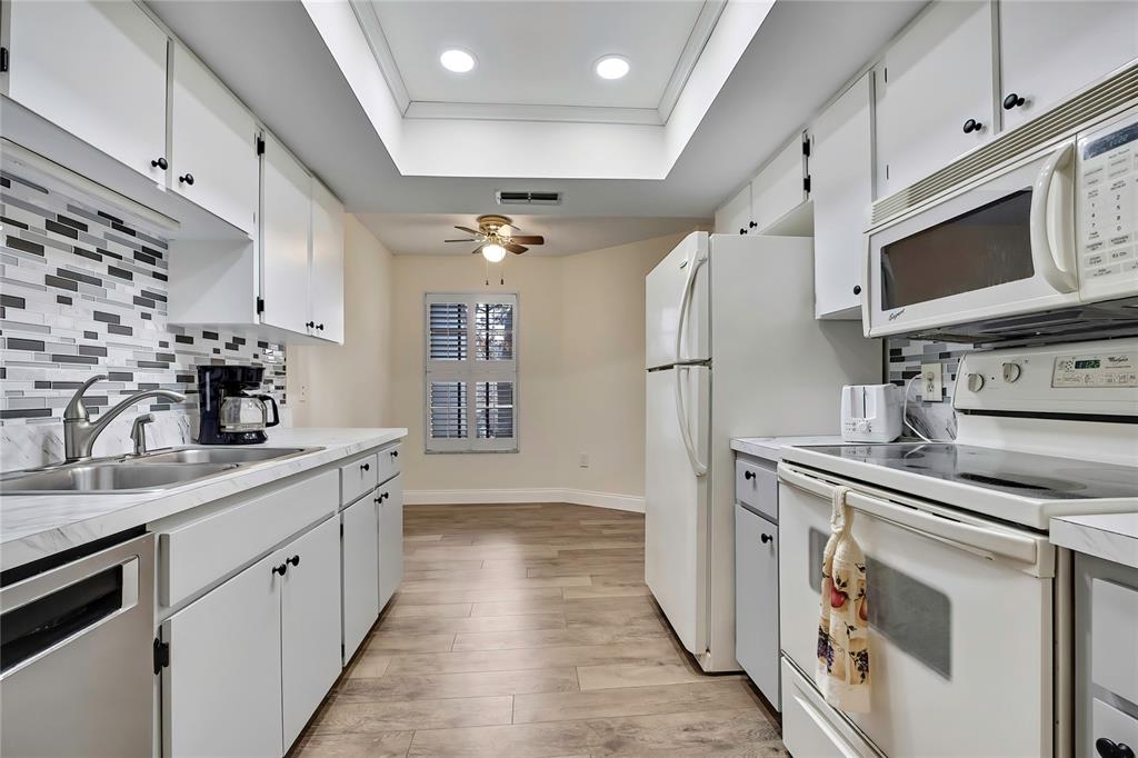 6365 Nature Preserve Lane Spring Hill, FL 34606 - Photo 2 of 26 a kitchen with stainless steel appliances a stove microwave and sink