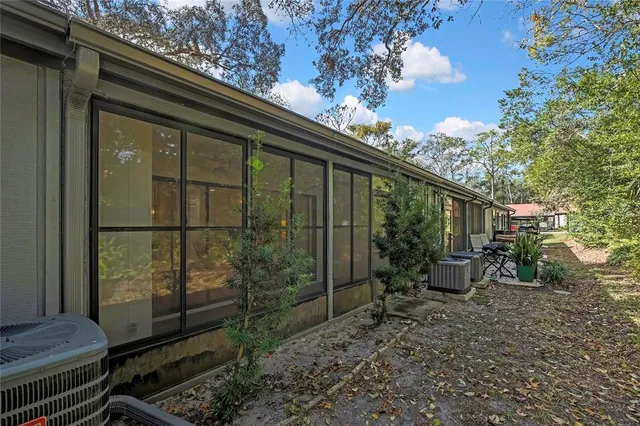 a backyard of a house with table and chairs