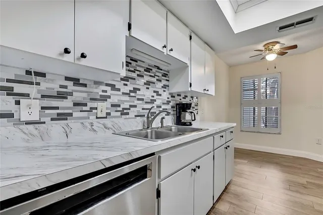 a kitchen with kitchen island a sink stove and cabinets