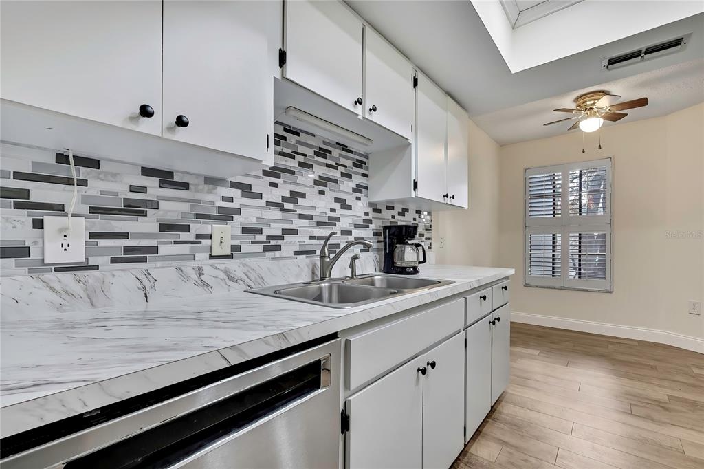 6365 Nature Preserve Lane Spring Hill, FL 34606 - Photo 3 of 26 a kitchen with kitchen island a sink stove and cabinets