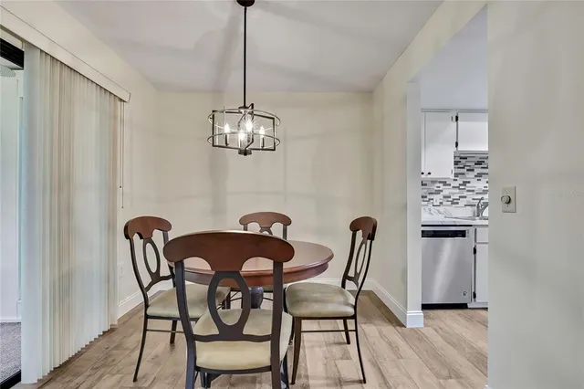 a dining room with furniture and chandelier
