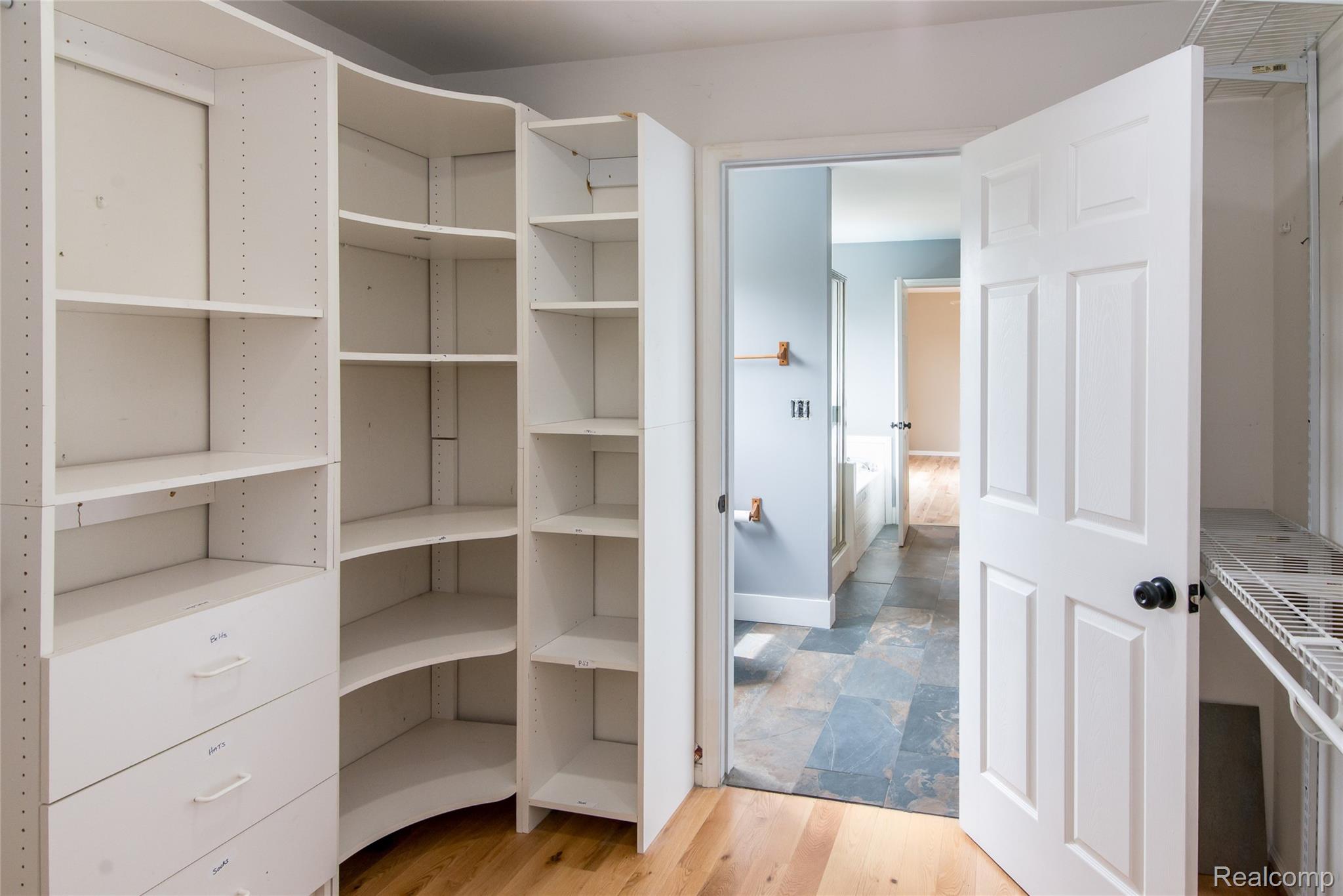 486 Sweet Briar Ridge Linden, MI 48451 - Photo 47 of 69 White built-in shelving with drawers and curved corner shelves