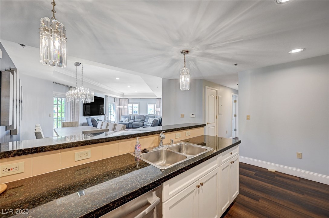 30 Strada Di Villaggio, Unit 250 Henderson, NV 89011 - Photo 52 of 52 Kitchen with recessed lighting, a chandelier, dark wood finished floors, a tray ceiling, and open floor plan