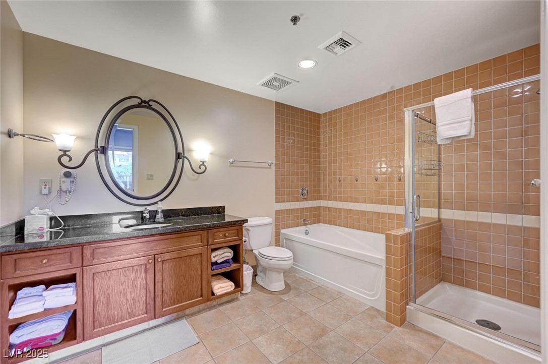 30 Strada Di Villaggio, Unit 250 Henderson, NV 89011 - Photo 17 of 52 Bathroom featuring vanity, a shower stall, light tile patterned floors, a bath, and recessed lighting