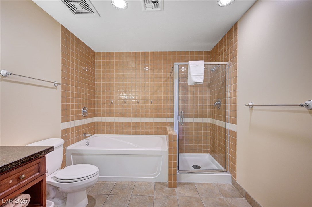 30 Strada Di Villaggio, Unit 250 Henderson, NV 89011 - Photo 20 of 52 Bathroom with a stall shower, a garden tub, light tile patterned floors, vanity, and recessed lighting