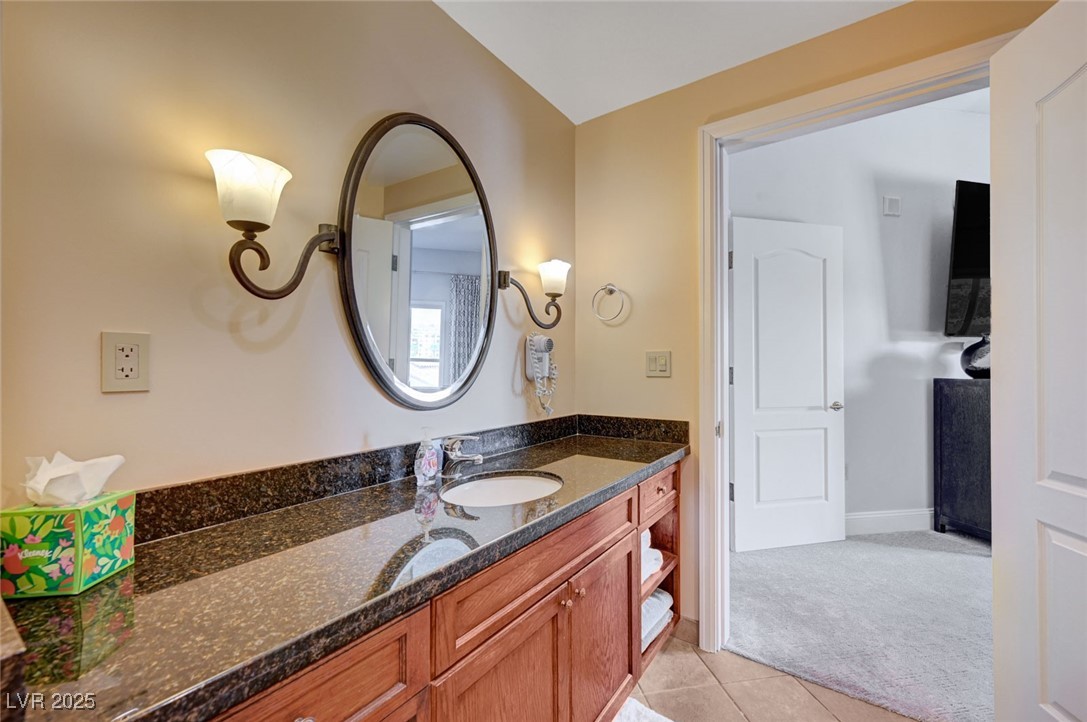 30 Strada Di Villaggio, Unit 250 Henderson, NV 89011 - Photo 25 of 52 Bathroom featuring vanity, light tile patterned floors, and light carpet