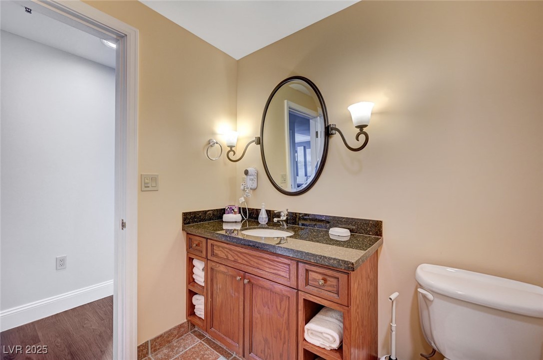 30 Strada Di Villaggio, Unit 250 Henderson, NV 89011 - Photo 29 of 52 Half bathroom featuring vanity and wood finished floors