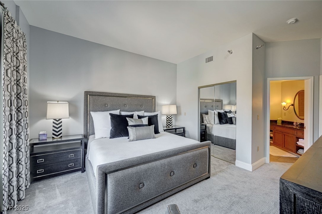 30 Strada Di Villaggio, Unit 250 Henderson, NV 89011 - Photo 36 of 52 Bedroom featuring light carpet, a closet, and connected bathroom