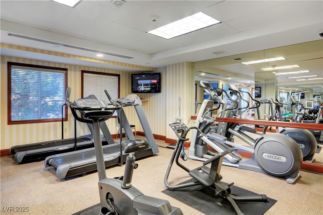 30 Strada Di Villaggio, Unit 250 Henderson, NV 89011 - Photo 47 of 52 Exercise room featuring wallpapered walls and a paneled ceiling