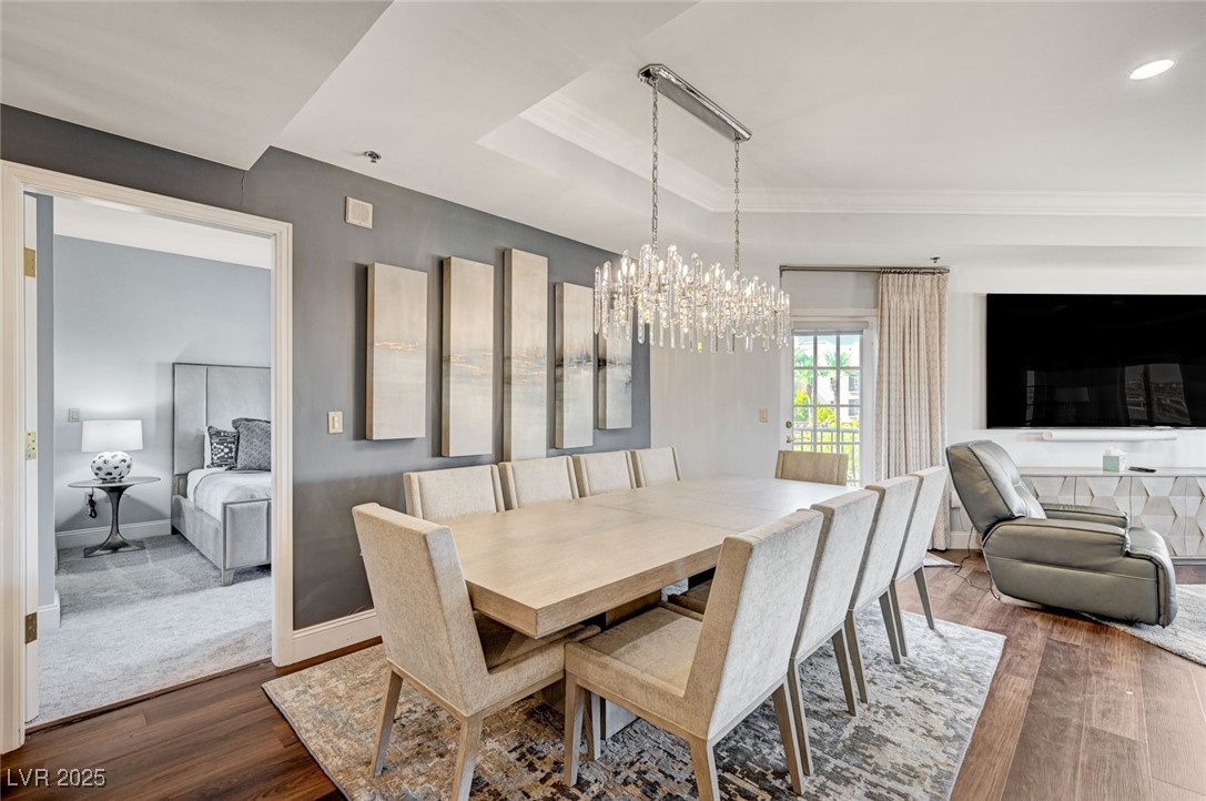30 Strada Di Villaggio, Unit 250 Henderson, NV 89011 - Photo 5 of 52 Dining space featuring dark wood-type flooring, a raised ceiling, and a chandelier