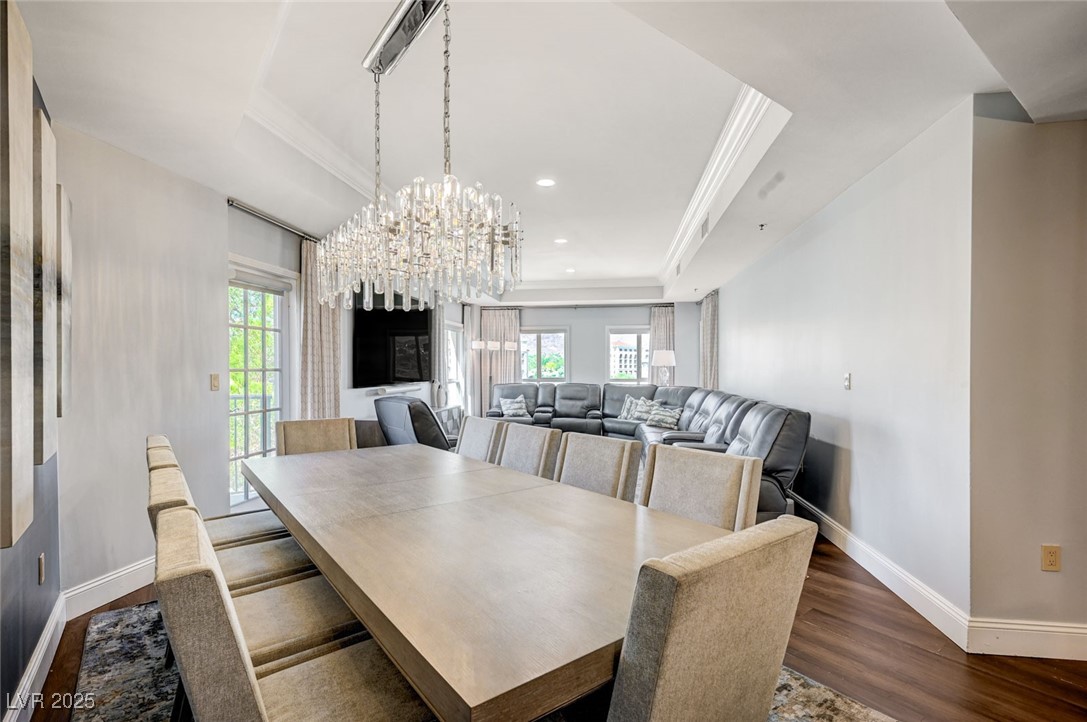 30 Strada Di Villaggio, Unit 250 Henderson, NV 89011 - Photo 6 of 52 Dining space featuring a tray ceiling, a chandelier, dark wood-style floors, ornamental molding, and recessed lighting