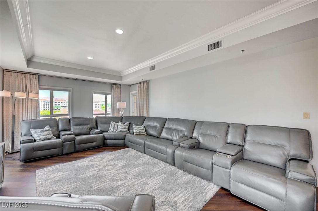 30 Strada Di Villaggio, Unit 250 Henderson, NV 89011 - Photo 7 of 52 Living area featuring ornamental molding, a tray ceiling, dark wood finished floors, and recessed lighting