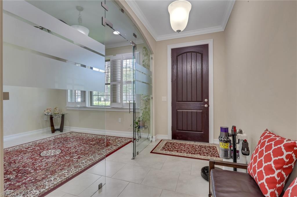 16309 Aberdeen Way Naples, FL 34110 - Photo 3 of 34 a view of livingroom with hardwood floor and a chandelier