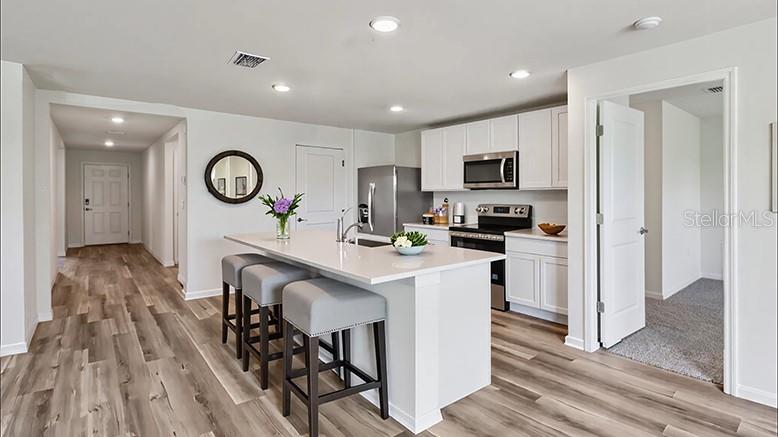 4777 Southwest 89th Street Ocala, FL 34476 - Photo 3 of 12 a kitchen with a table and a stove top oven