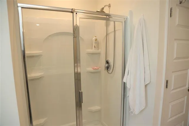 a bathroom with a glass shower door