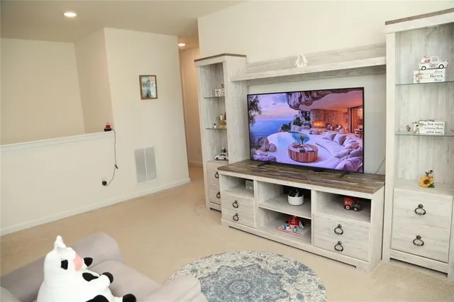 a view of room with painting on the wall and dresser