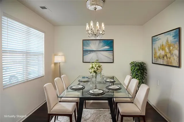a view of a dining room with furniture and chandelier