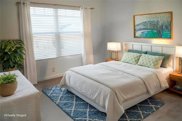 a bedroom with a bed and a potted plant