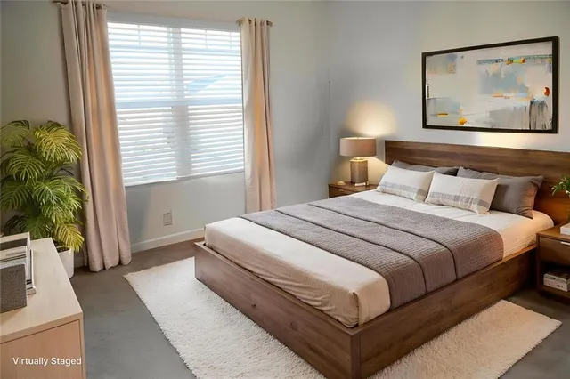 a bedroom with bed and paintings on the wall