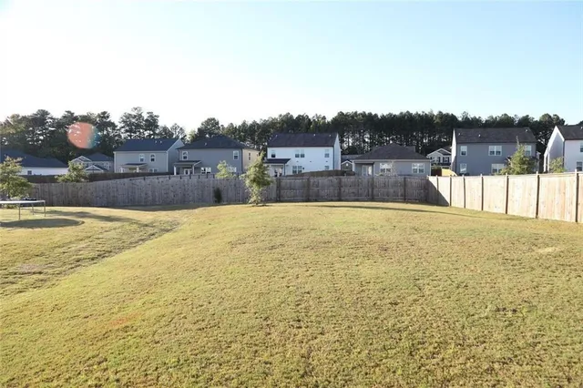 a swimming pool with outdoor seating and yard