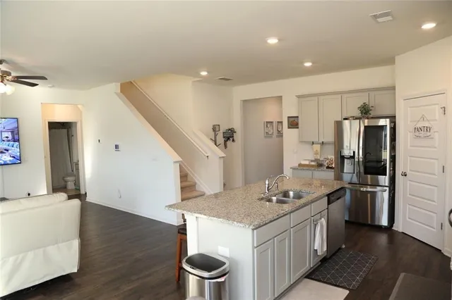 a kitchen with a sink and refrigerator
