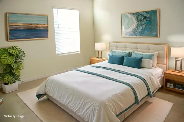 a bedroom with a bed and a painting on the wall