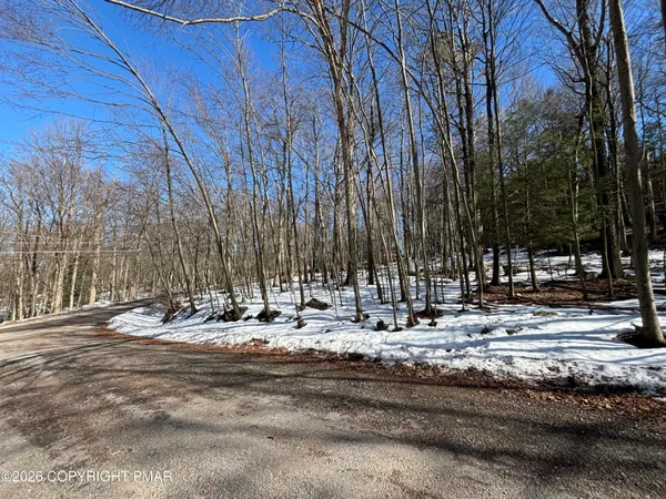 a view of the house with snow on the road