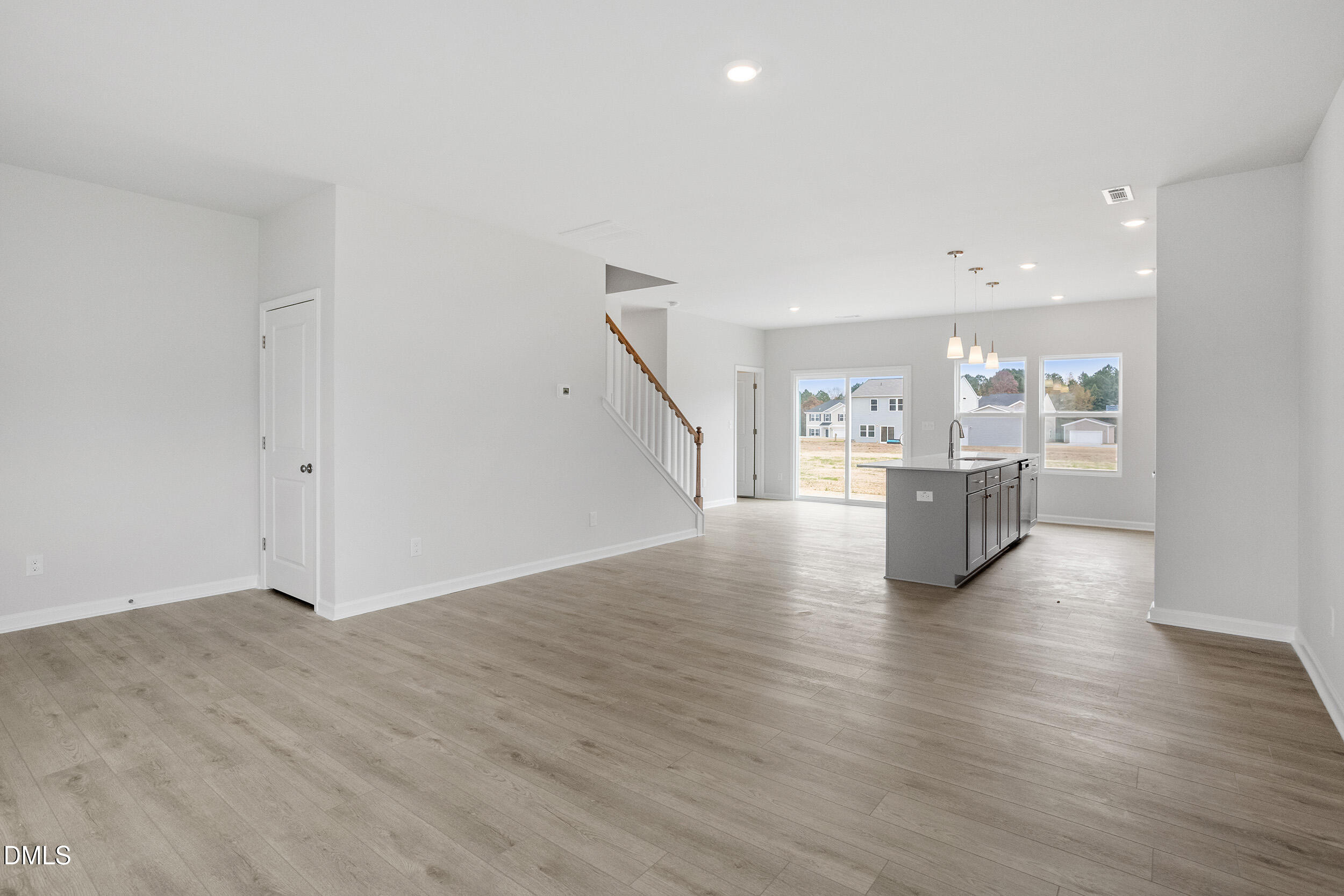 79 Osgood Street Angier, NC 27501 - Photo 10 of 31 a view of a kitchen with wooden floor electronic appliances and stairs