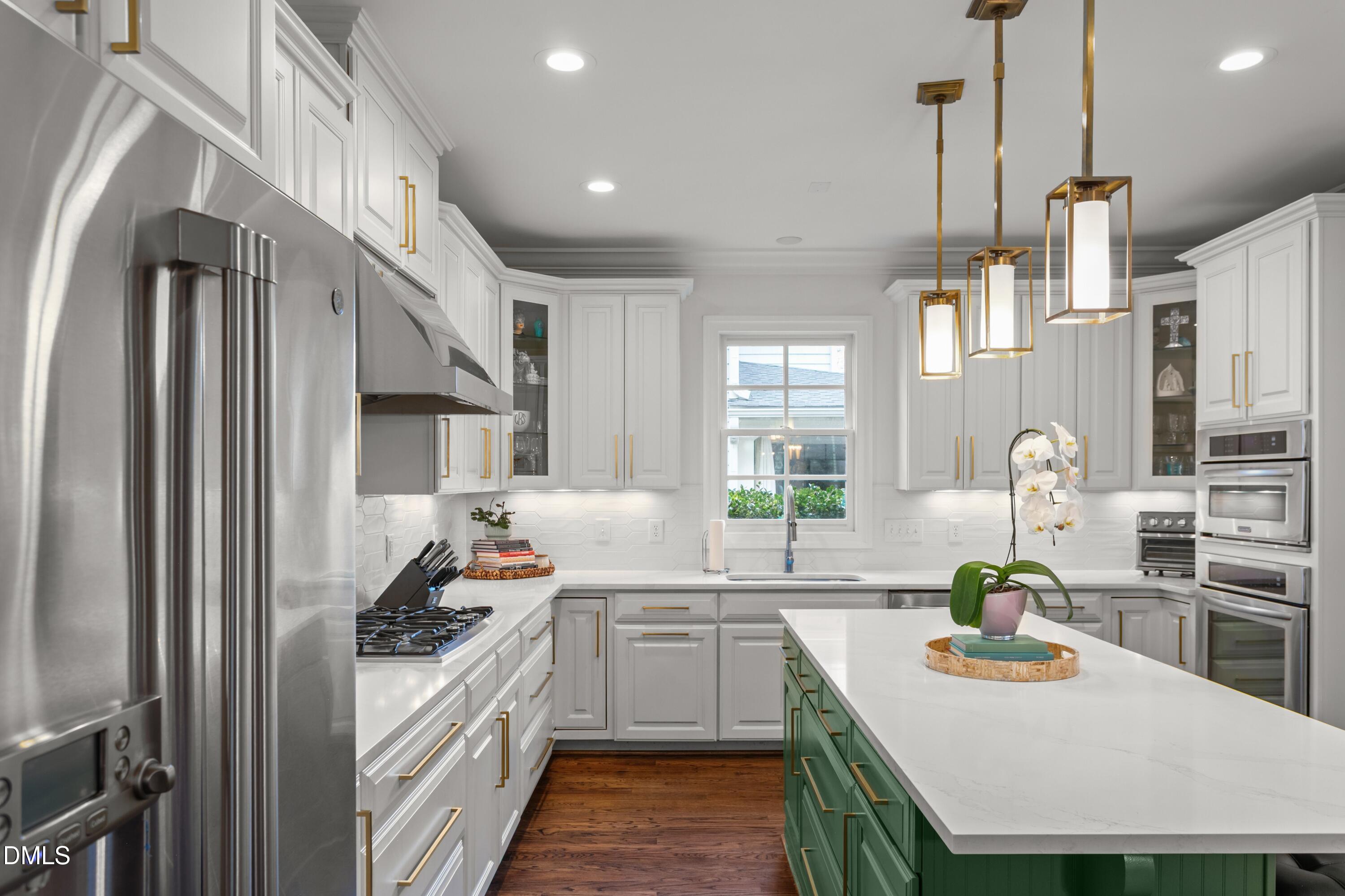 514 Wayne Drive Raleigh, NC 27608 - Photo 14 of 53 a kitchen with sink a stove and chairs