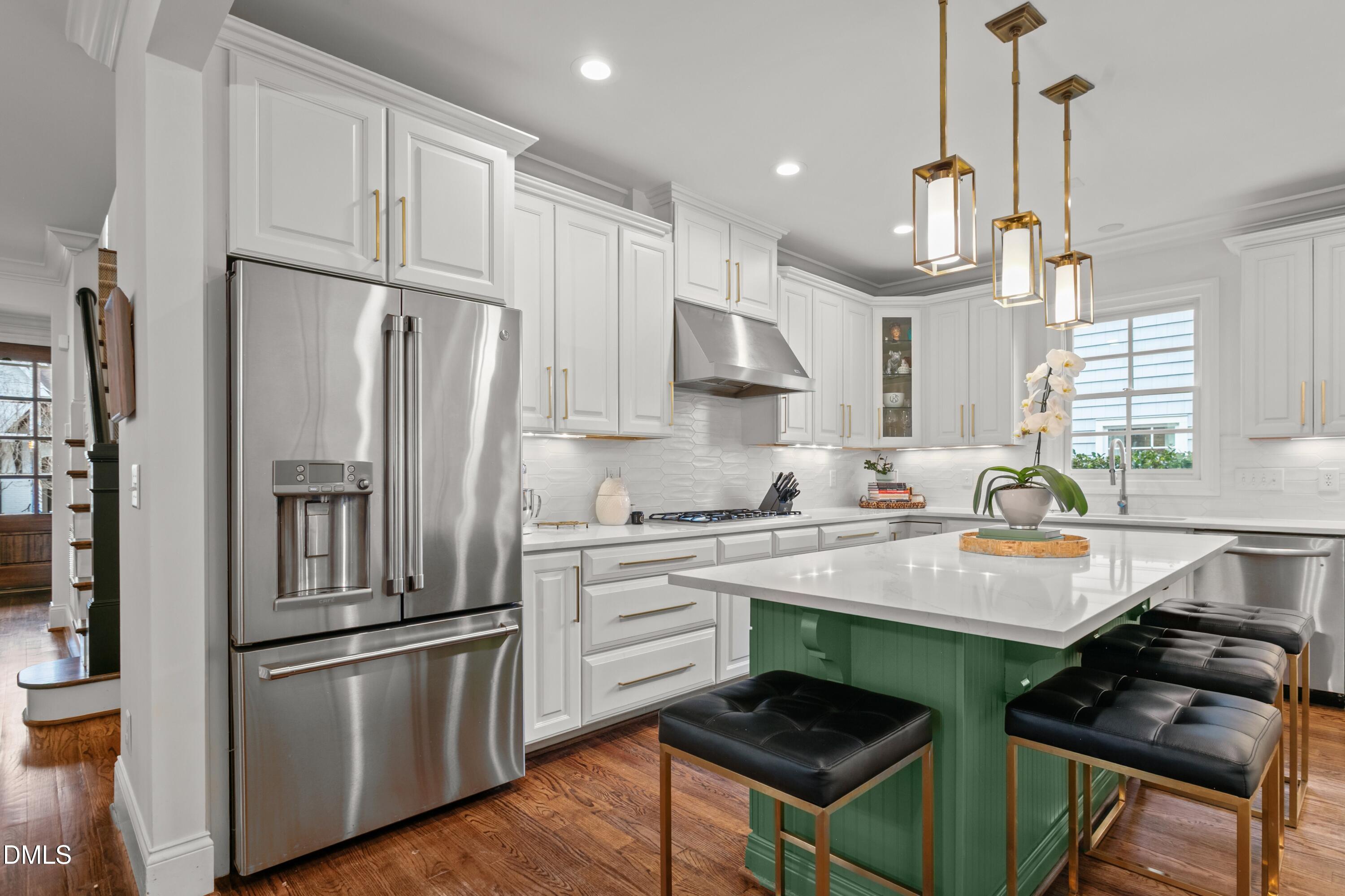 514 Wayne Drive Raleigh, NC 27608 - Photo 15 of 53 a kitchen with kitchen island a counter space a sink appliances and cabinets