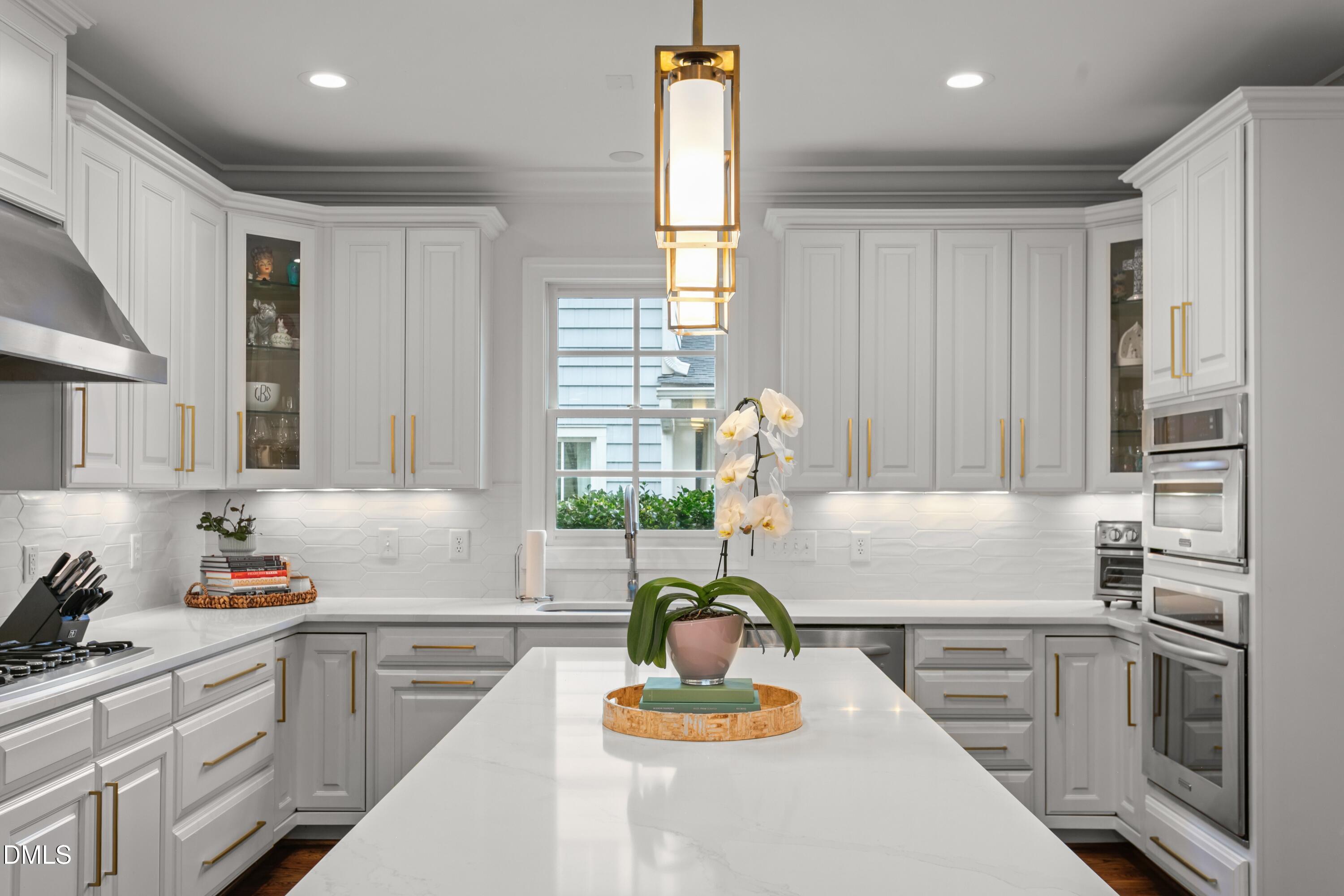 514 Wayne Drive Raleigh, NC 27608 - Photo 16 of 53 a kitchen with kitchen island granite countertop a sink stainless steel appliances and cabinets