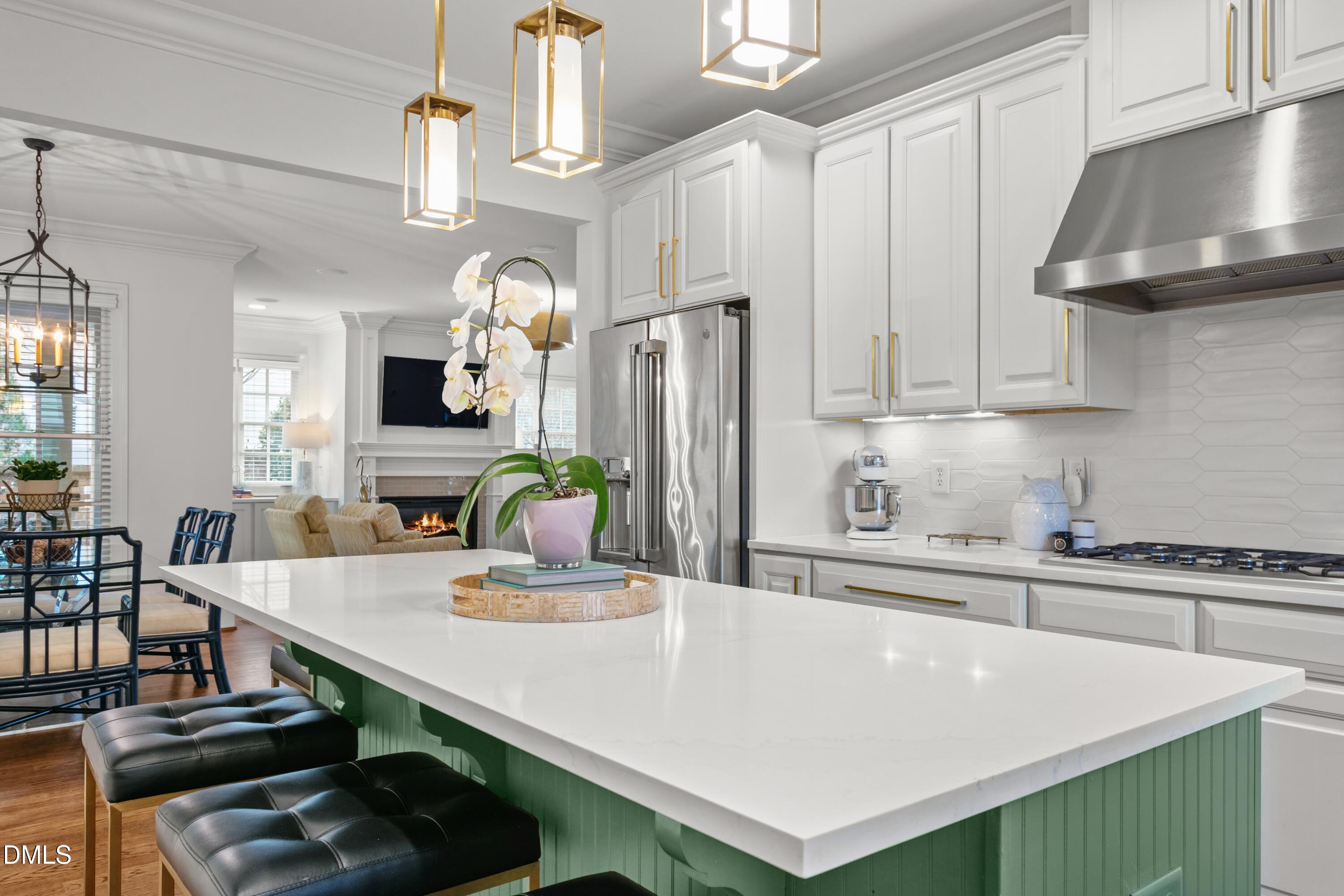 514 Wayne Drive Raleigh, NC 27608 - Photo 17 of 53 a kitchen with kitchen island stainless steel appliances a sink stove and cabinets