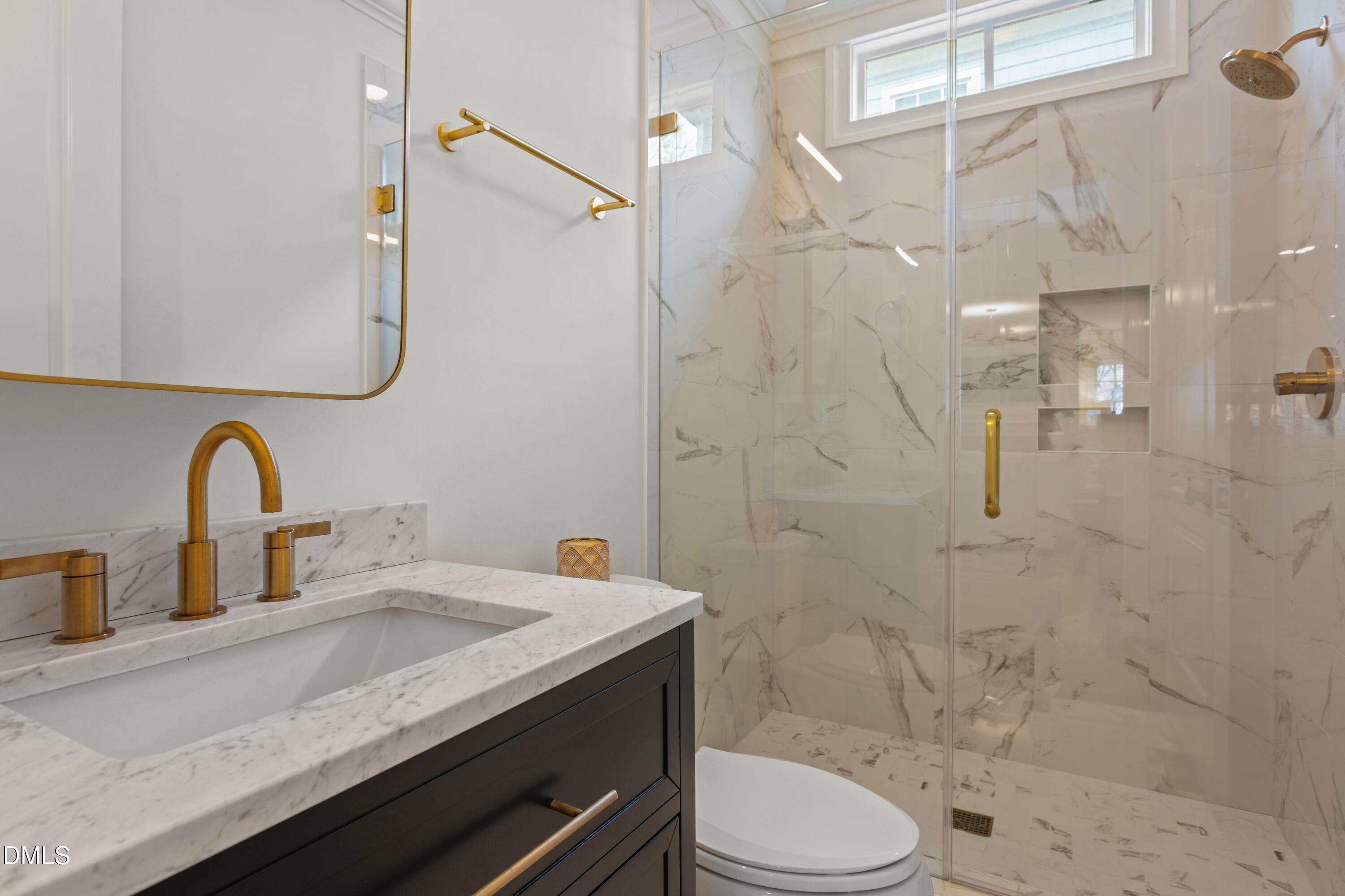 514 Wayne Drive Raleigh, NC 27608 - Photo 19 of 53 a bathroom with a granite countertop sink a toilet and shower