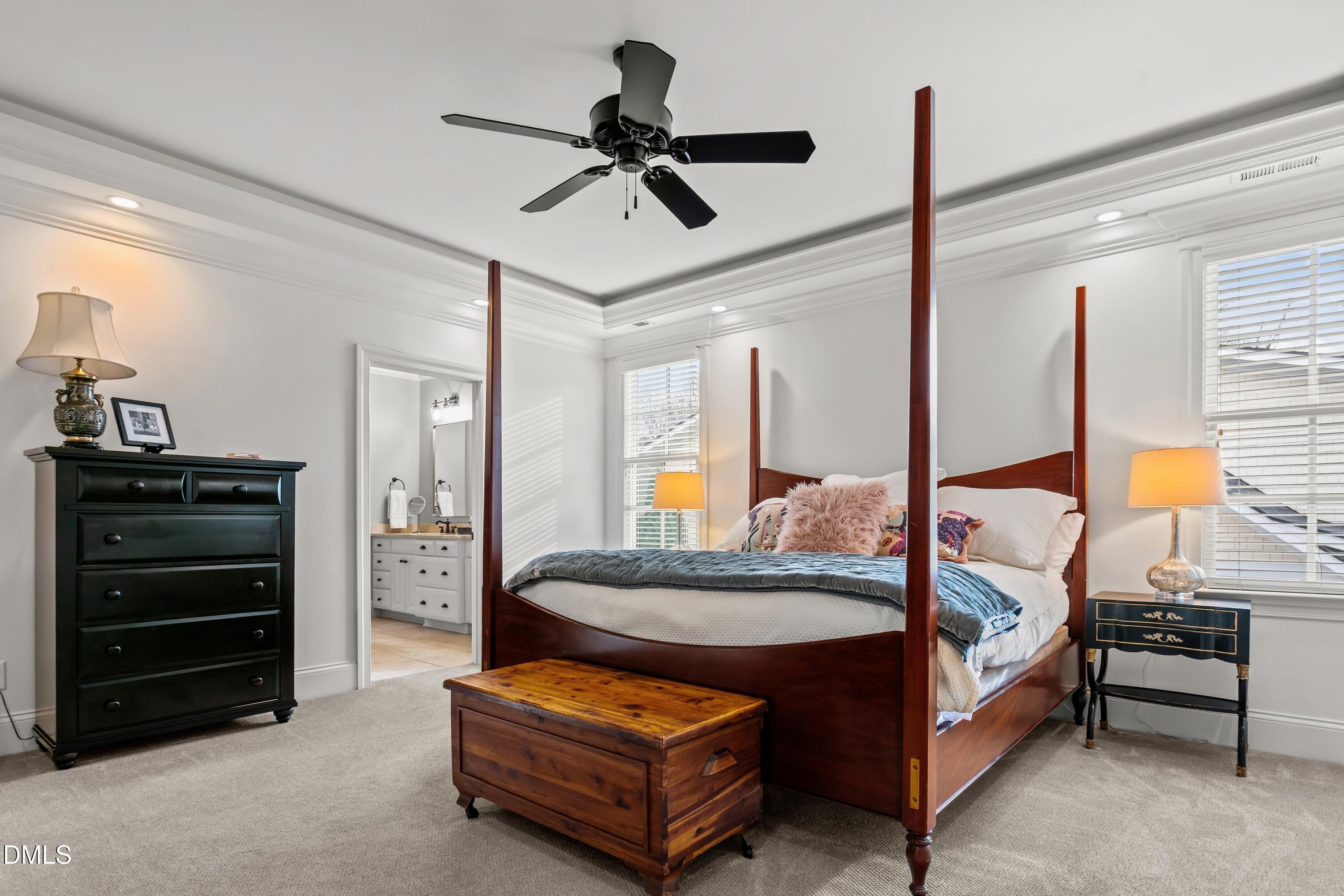 514 Wayne Drive Raleigh, NC 27608 - Photo 21 of 53 a bedroom with a bed a chandelier and a window