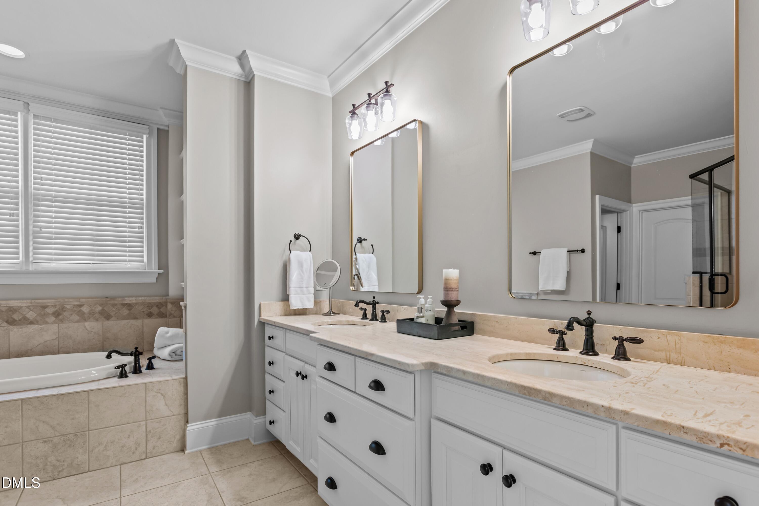 514 Wayne Drive Raleigh, NC 27608 - Photo 22 of 53 a bathroom with double vanity sinks double vanity tub shower and a mirror