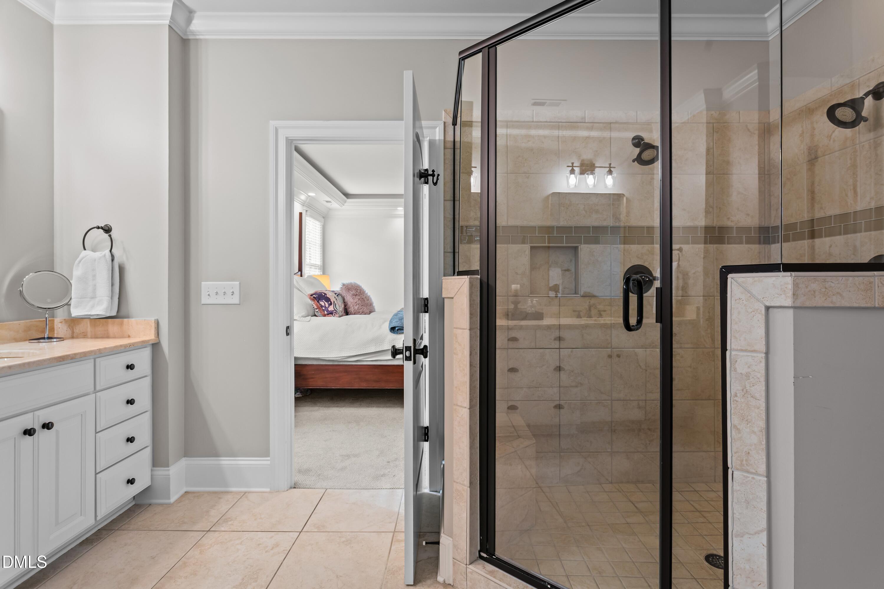 514 Wayne Drive Raleigh, NC 27608 - Photo 23 of 53 a en suite bathroom with a granite countertop sink a mirror and shower