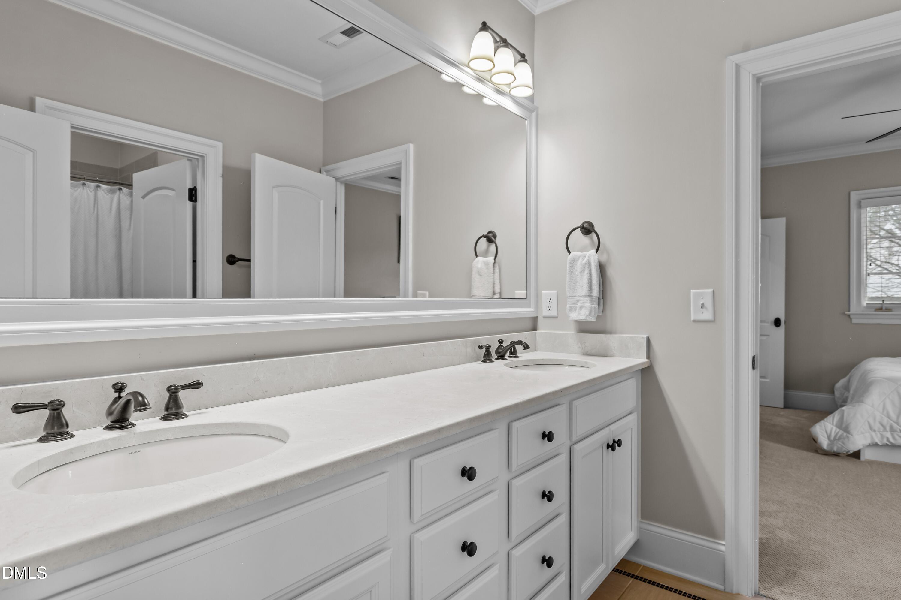514 Wayne Drive Raleigh, NC 27608 - Photo 25 of 53 a bathroom with double vanity sinks and a mirror