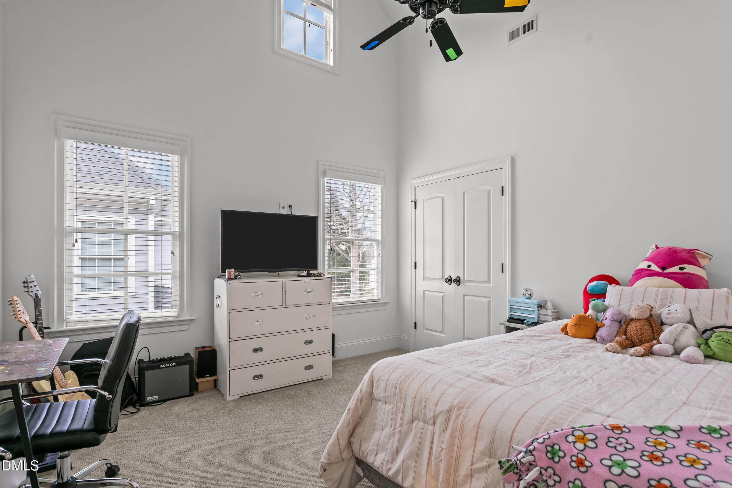 514 Wayne Drive Raleigh, NC 27608 - Photo 26 of 53 a bedroom with a bed and a flat screen tv