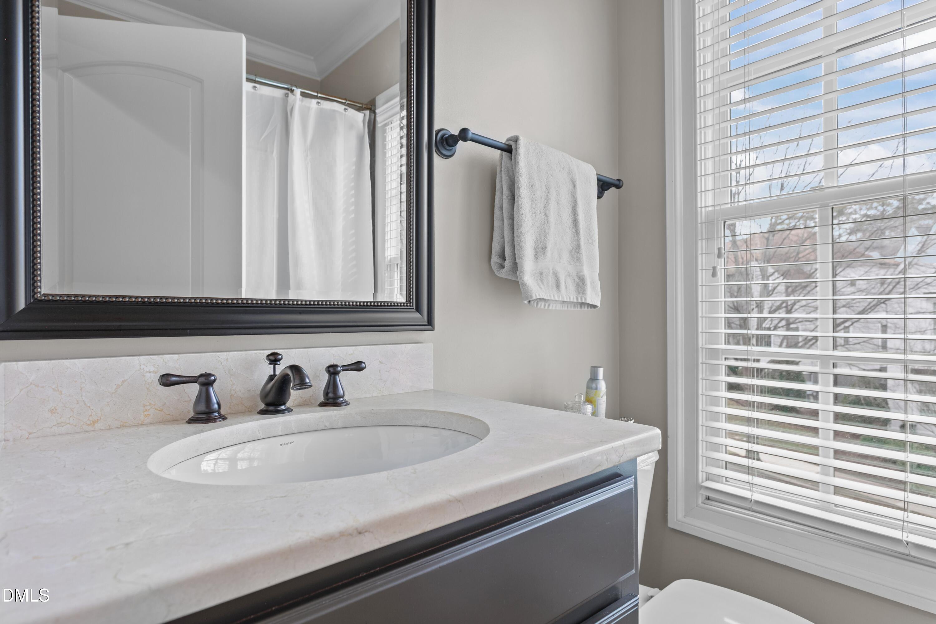 514 Wayne Drive Raleigh, NC 27608 - Photo 28 of 53 a bathroom with a sink and a mirror