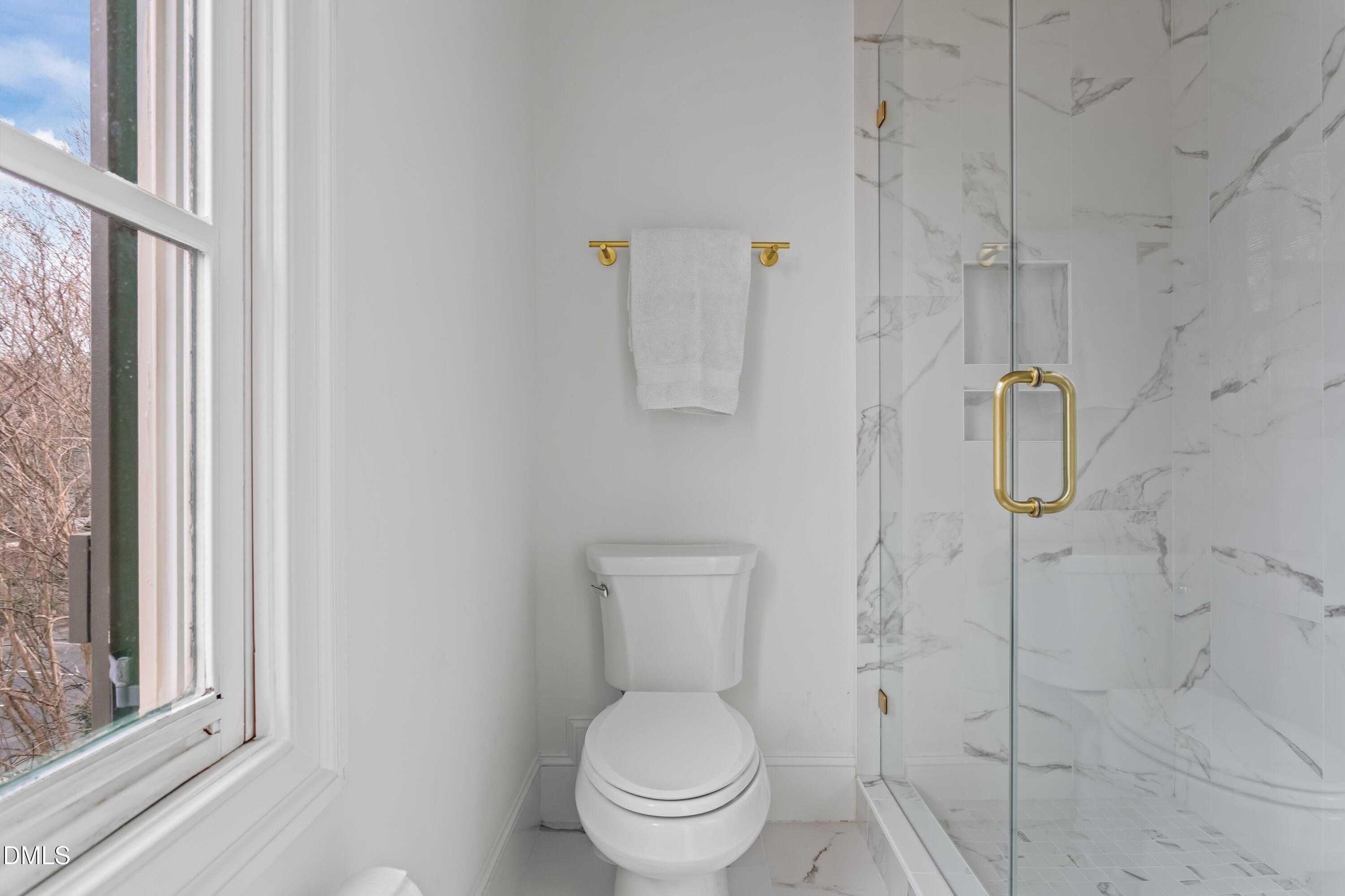 514 Wayne Drive Raleigh, NC 27608 - Photo 35 of 53 a white toilet sitting next to a bathroom sink
