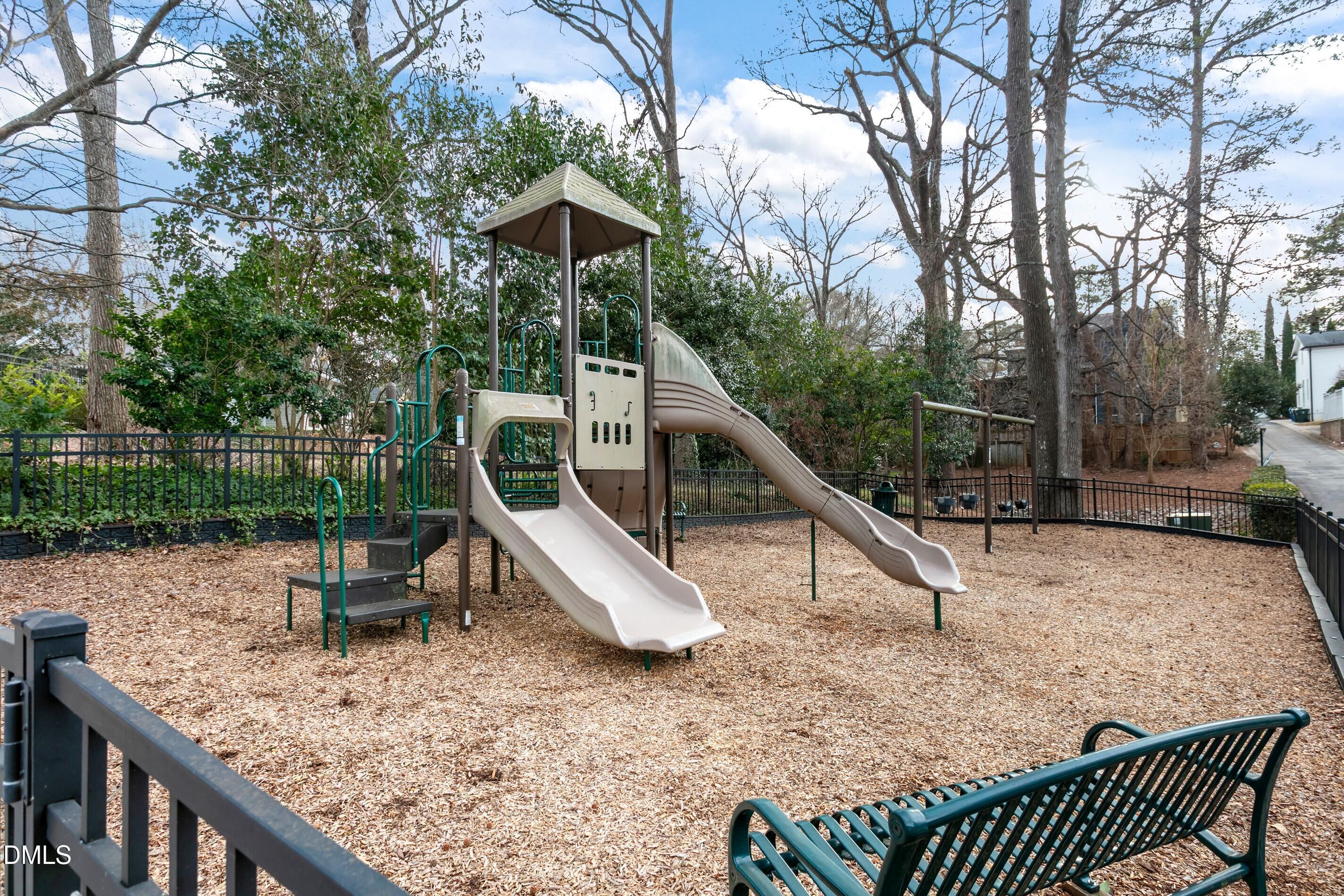 514 Wayne Drive Raleigh, NC 27608 - Photo 50 of 53 a view of a wooden deck with chairs and a slide
