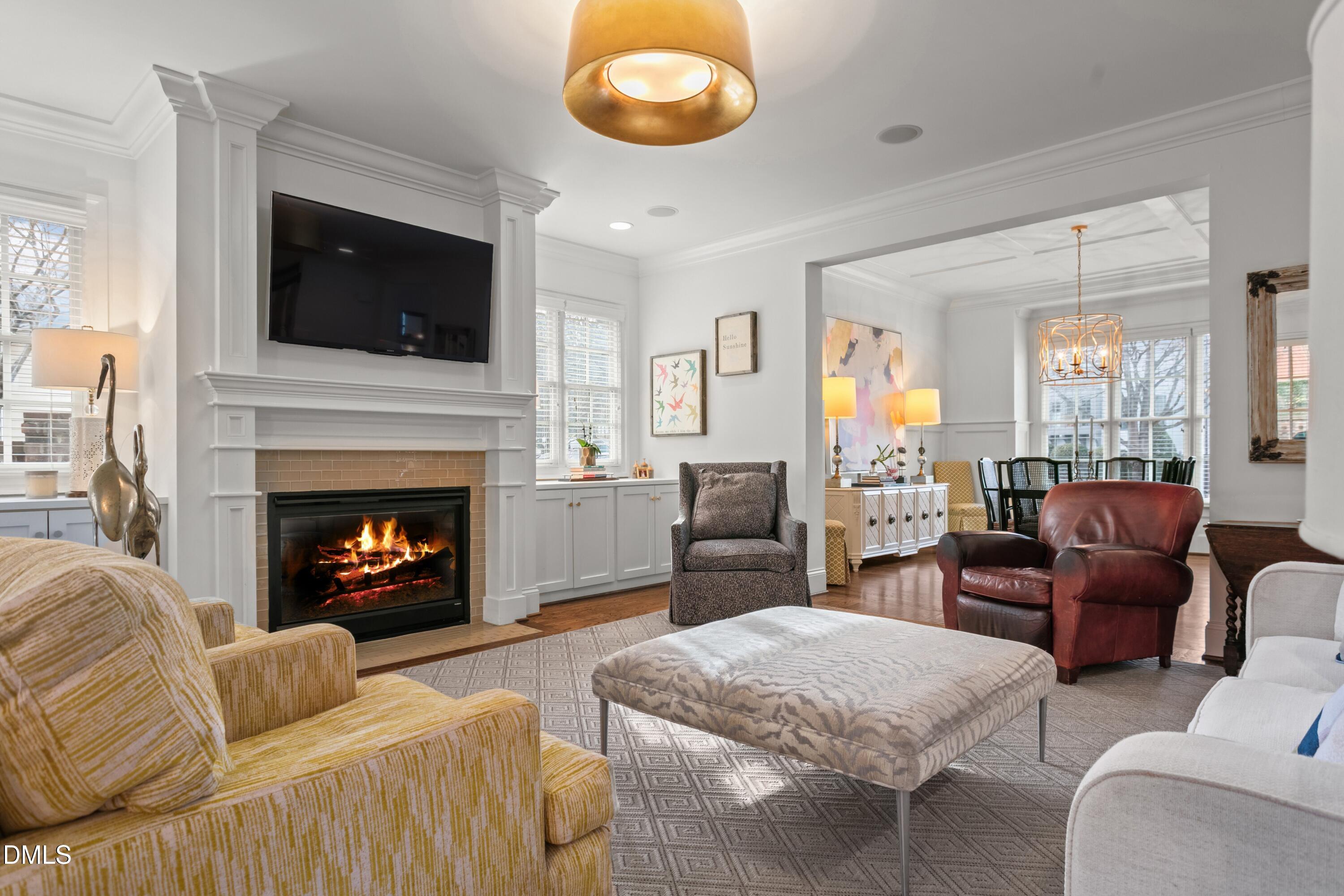 514 Wayne Drive Raleigh, NC 27608 - Photo 9 of 53 a living room with furniture flat screen tv and a fireplace