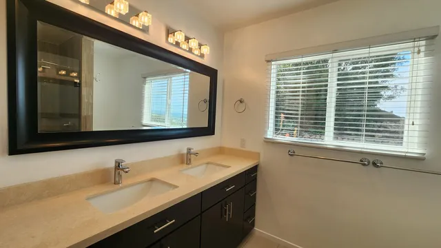 a bathroom with a sink and a large mirror