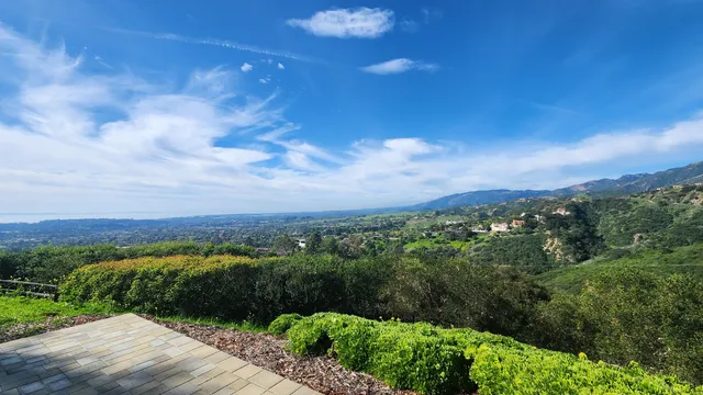 a view of a city street with a yard