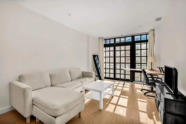 a bedroom with a bed a table and chair