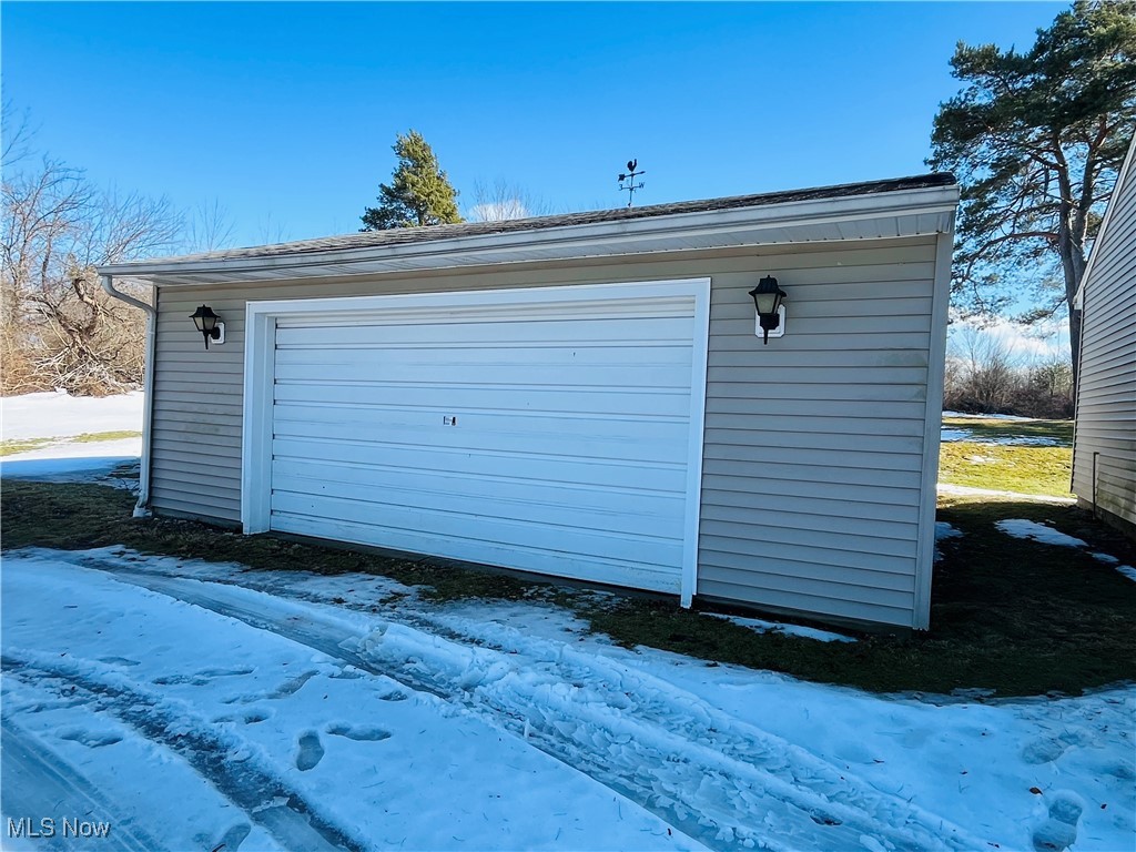 3210 Austinburg Road Ashtabula, OH 44004 - Photo 15 of 48 Snow covered garage featuring a garage